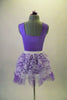 Pale lavender leotard has pinch front with jewelled brooch accent and wide shoulder straps. The matching lavender tulle and white lace pull-on skirt. Completes the pretty look. Comes with matching floral hair accessory. Back