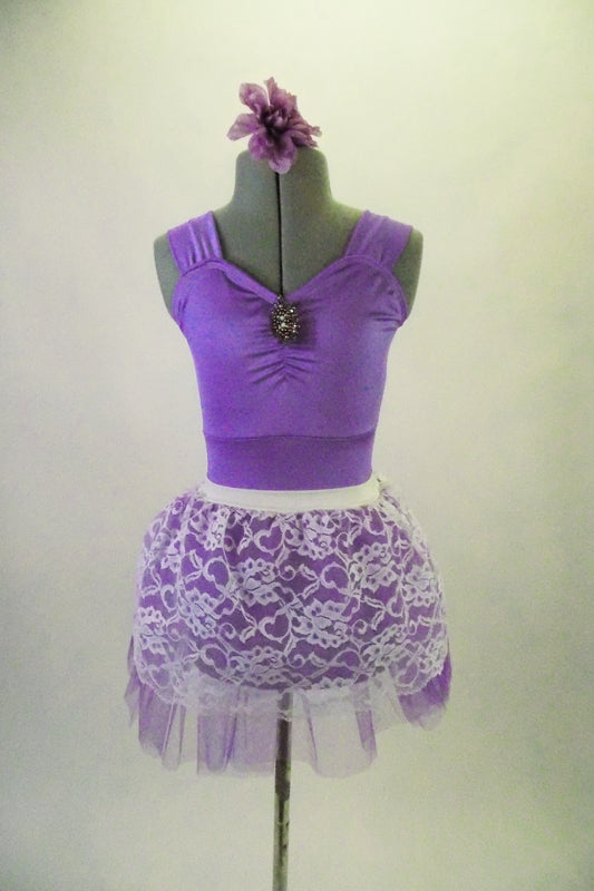 Pale lavender leotard has pinch front with jewelled brooch accent and wide shoulder straps. The matching lavender tulle and white lace pull-on skirt. Completes the pretty look. Comes with matching floral hair accessory. Front