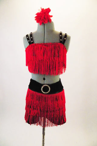 Two-piece costume has red fully fringed half-top with double black crystalled straps. The matching fringed shorts have a wide black waistband with crystal belt buckle accent. Comes with matching bottom is blue shorts with blue tulle skirt and matching silver crackle overlay. Comes with a crystal hair accessory. Front