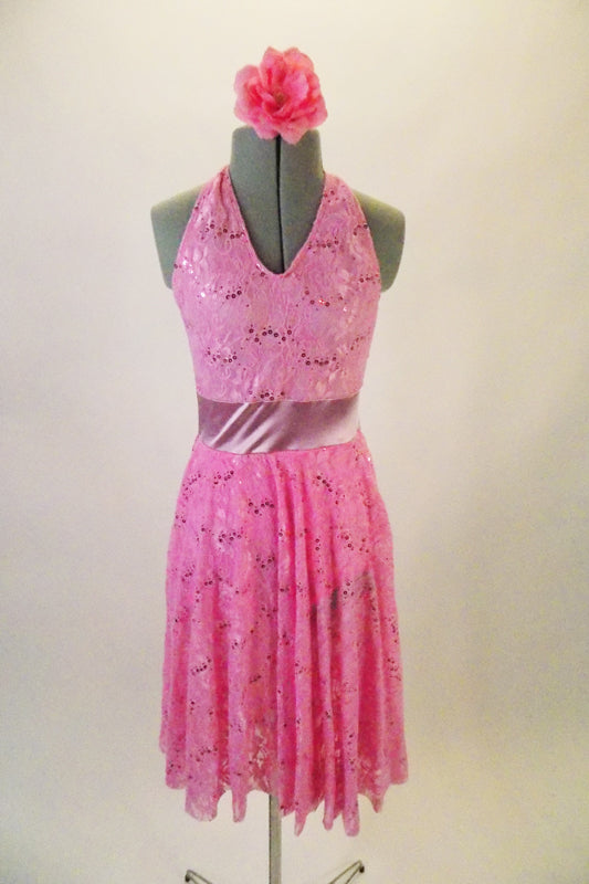 Pretty pink sequined lace V-neck halter dress has satin stretch waistband and full circle skirt. Comes with matching floral hair accessory. Front