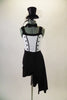 Black & white costume has top hat and tails theme. White torso has a button coat detail with black piping. The attached black shorts have a one-sided black skirt that wraps around the left hip. Comes with black bow tie and glittery top-hat accessory. Front