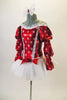 Red and white costume has red shiny bodice, large white polka dots & princess cut crystalled piping. The triple pouffed Bishop sleeves accent the off-shoulder cut with white ruffling. The finely pleated white tutu skirt has red bow accents. Left side