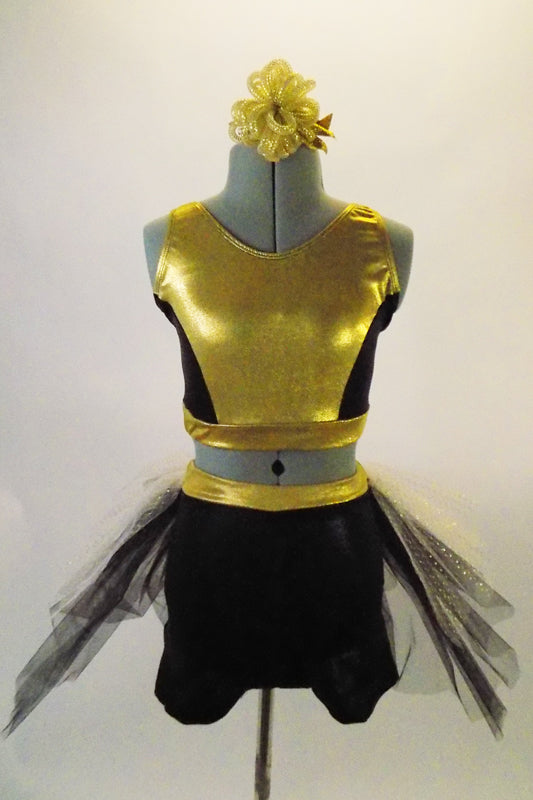 Gold & black two-piece costume has a gold and black half top. The bottom is black shorts with gold waistband and attached black-white-gold tulle bustle skirt.Comes with matching gold hair accessory. Front