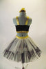 Gold & black two-piece costume has a gold and black half top. The bottom is black shorts with gold waistband and attached black-white-gold tulle bustle skirt.Comes with matching gold hair accessory. Back