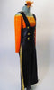 Two- piece costume has black leatherette pants with a wide leg and gold side stripe, has attached suspenders and gold front button accents. The long-sleeved, scoop neck orange velvet half-top has gold neckline to compliment the gold heart pattern. Comes with a hair accessory. Side