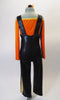 Two- piece costume has black leatherette pants with a wide leg and gold side stripe, has attached suspenders and gold front button accents. The long-sleeved, scoop neck orange velvet half-top has gold neckline to compliment the gold heart pattern. Comes with a hair accessory. Back