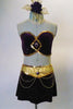 Arabian flare, nude mesh glitter tank leotard has purple glitter velvet bust area lined with gold sequins and brooch accent. The wide gold waistband has matching brooch accent with gold chains and an attached purple glitter velvet shirt with side slits. Comes with a hair accessory. Front