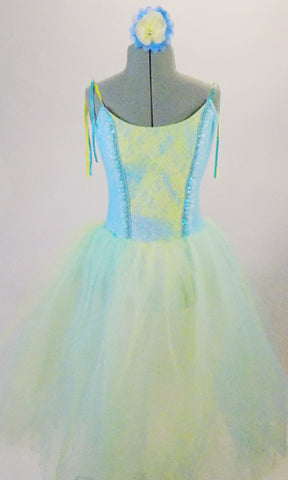 Romantic tutu dress has a pale blue bodice with blue and yellow lace front panel accented with sequined ruffle. The full tulle skirt has layers of pale blue, green and yellow for a soft pleasant flowy look. Comes with matching floral hair accessory. Front