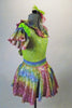 Iridescent dress has pale green bodice with rainbow coloured ruffles around the neckline and matching skirt. The neon green petticoat gives the skirt a nice fullness.  Comes with matching ruffled armband floral hair accessory. Right side