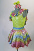 Iridescent dress has pale green bodice with rainbow coloured ruffles around the neckline and matching skirt. The neon green petticoat gives the skirt a nice fullness.  Comes with matching ruffled armband floral hair accessory. Left side