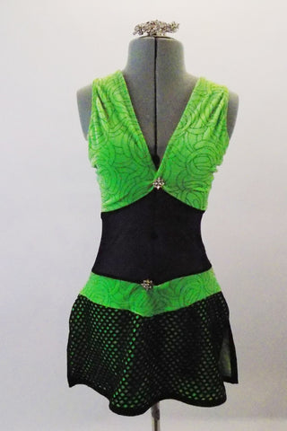 Black mesh and green velvet sparkle velvet costume has a black large meshed skirt and wide crossed back straps. Has crystal details at bust and waist. Comes with long mesh gauntlets and crystal hair barrette. Front