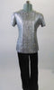 Silver textured top with round neck and short sleeves is complemented by black pants with black and silver lacing up the outside of the lower leg. Comes with a silver hair clip. Front