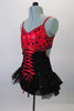 Gorgeous leotard with corset lace up front and open back had red and black polka dot bust and black sequined bottom with layered bustle skirt. The black sequined mini shrug with matching red piping sits on shoulders just above the bra leaving the lower back exposed. Left side