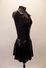 Black sequined halter leotard has black patent leatherette collar, accents and rhinestone zip front. The matching leatherette skirt has plaid lining the inner pleats. A black leatherette Brixton Brood cap completes the rebel look. Side