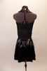 Black sequined halter leotard has black patent leatherette collar, accents and rhinestone zip front. The matching leatherette skirt has plaid lining the inner pleats. A black leatherette Brixton Brood cap completes the rebel look. Back