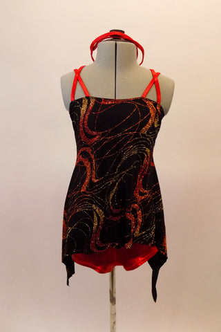 2-piece costume has red metallic booty shorts accompanied by black tunic top with gold red and copper glitter swirls. The tunic has red double straps that cross at the shoulders to the back. Comes with matching red metallic headband accessory. Front