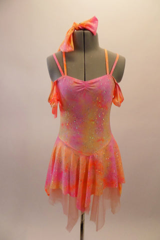 Soft shades of pinks and corals with cascades of gold sparkle create this lovely leotard dress. The double shoulder straps come together at a loop in the back center for good support. The attached short flounce skirt has a layer of sheer muslin in a pale blush.  Comes with matching hair accessory. Front