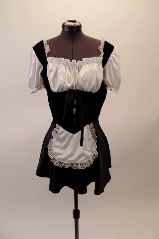 Black and white French maid costume has black velvet upper and satin skirt. The torso has an under-bust lace corset beneath a with gathered blouson bust and pouffe sleeves. Comes with a separate bottom and attached apron. Front