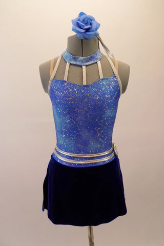 Gorgeous sparkle sky blue halter collar leotard dress has navy velvet attached short skirt with side slit. The waist is accented with double silver belt accent and large crystal brooch. The silver piping is also prominent in the neckline with five silver straps joining the bust to the neckband. The dress is reinforced with nude elastic shoulder straps. Comes with a blue floral hair accessory. Front