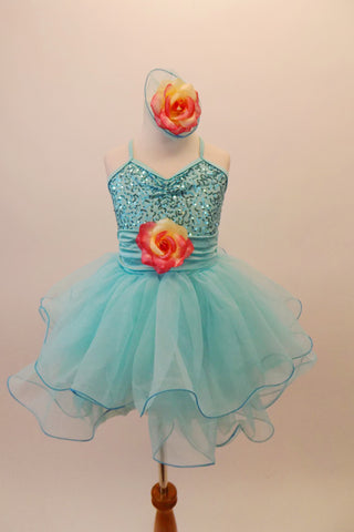 Sweet pale aqua dress has glitter sequin bodice, cummerbund waist and double layered curly hemmed There is a large yellow and coral rose at the waist.  Comes with matching rose hair accessory. Front