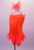 Cheery bright orange sequined short unitard shows well on stage. It has sheer polka dot ruffle skirt and cross back straps. Comes with matching bow hair accessory. Side