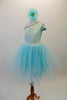 Delicate pale aqua romantic tutu dress has a single shoulder sparkle bodice with sequined trim and butterfly sleeves. Multiple layers of soft aqua tulle comprise the skirt. Comes with a floral hair accessory. Left side