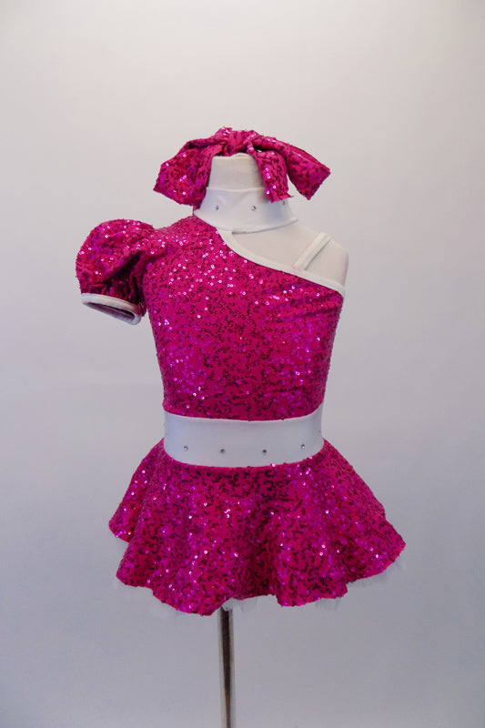 Sweet fuchsia sequined dress has a single shoulder with pouffe sleeve and attached white choker collar. The open shoulder has white shoulder straps that match the white crystalled waistband. Comes with matching sequined hair tie. Front