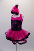 Fuchsia dress has black sparkle torso and wide cross-back straps. The fuchsia sheer double layered attached skirt has black ribbon edging. Comes with pink and black feather hair accessory and sparkle gauntlets. Side