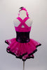 Fuchsia dress has black sparkle torso and wide cross-back straps. The fuchsia sheer double layered attached skirt has black ribbon edging. Comes with pink and black feather hair accessory and sparkle gauntlets. Back 