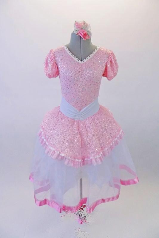 Delicate romantic tutu dress has pale pink lace bodice and overlay with pouffe sleeves, lace trim and wide gathered waistband. The long white tulle skirt has a pink satin ribbon trim.  Comes with matching floral hair accessory. Front
