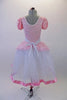 Delicate romantic tutu dress has pale pink lace bodice and overlay with pouffe sleeves, lace trim and wide gathered waistband. The long white tulle skirt has a pink satin ribbon trim.  Comes with matching floral hair accessory. Back