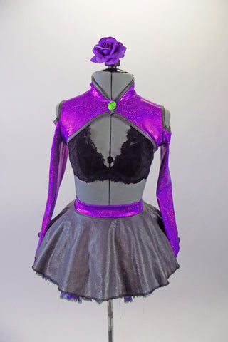 three-piece costume has a black lace bra base (30A) with purple sparkle, long sleeved, cold shoulder shrug with neon green button accent. The accompanying skirt is a concrete grey overlay on top of purple & green tulle & matching waistband with large green bow at the back. Comes with floral hair accessory. Front