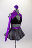 three-piece costume has a black lace bra base (30A) with purple sparkle, long sleeved, cold shoulder shrug with neon green button accent. The accompanying skirt is a concrete grey overlay on top of purple & green tulle & matching waistband with large green bow at the back. Comes with floral hair accessory. Side