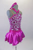 Sweet two-piece costume has white circular sparkle pattern on the bodice of a metallic pink base. The hater neck straps originate from a ring at the front of the bodice. The accompanying pull-on skirt is metallic pink with white tulle for volume. Comes with a purple floral hair accessory. Side
