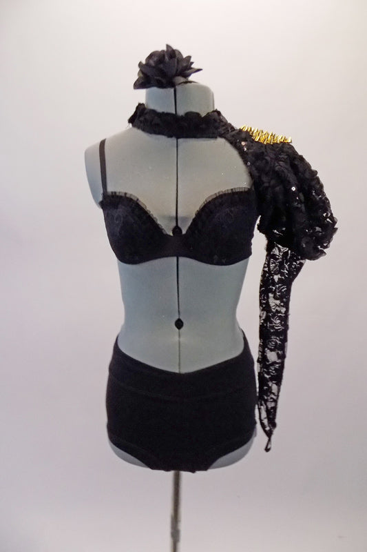 Black lace push-up bras with ruffle accent is accompanied by a lace choker collar shrug with gold studs on the shoulder. The black booty shorts and black lace studded gauntlet complete the look. Comes with a black floral hair accessory. Front