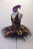 Peacock themed ballet tutu has a black base with beautiful gold & purple embroidered lace designs on the bodice & sheer overlay. The nude straps cross over at the back for good support. The accompanying black pull-on tutu & black briefs create the stunning base. Comes with a large matching hair accessory. Left side