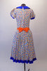 50s housewife themed, pouffe sleeved dress is a white base with colourful squares of blues, yellow & orange. The blue theme is repeated in the collar, sleeve cuffs, buttons & ruffled skirt hem. The orange attached apron compliments the square pattern in the dress with blue crystal accents. Comes with a hair accessory. Back