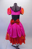 Theatrical dress is both peasant and royalty all at once. The layers of petticoat and pink bustle with a bow, create loads of volume beneath a colourful skirt in shades of red pink & orange. The skirt portion of the dress compliments the pink bodice, ruffled neckline, pouffe sleeves and faux corset laced waistband. Comes with Pink rose hair clip. Back