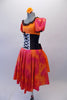 The layers of petticoat and orange bustle with bow, create loads of volume beneath a colourful skirt in shades of red pink & orange. The skirt portion of the dress compliments the orange bodice, ruffled neckline, pouffe sleeves and faux corset laced waistband. Left side