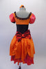 The layers of petticoat and orange bustle with bow, create loads of volume beneath a colourful skirt in shades of red pink & orange. The skirt portion of the dress compliments the orange bodice, ruffled neckline, pouffe sleeves and faux corset laced waistband. Back