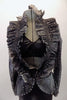 Eclectic costume is a short unitard in shades of grey-black with silver swirled fabric. The top is a faux peplum blazer with a pleated ruffle collar that crosses at the front waist to reveal a black bra beneath. Comes with crystal hair barrette. Front zoomed
