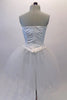 White crystalled ballet bodice has a sequined princess cut center with peaked font & nude sequined insert. There is a zipper closure at back. The white sheer overlay has scattered crystals like droplets of ice that sits over a white romantic pull-on tutu skirt. Comes with white floral hair accessory & removable straps. Back
