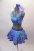 Three-piece costume has a leaf pattern in shades of blues & purples with a hint of a metallic accent. The crystal accented waistband & lace edging of the skirt are purple & accent the main pattern. The costume is scattered with blue & purple crystals throughout. Comes with briefs, gauntlets & hair accessory. Side