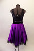 Purple and black tank style dress has a black scoop-neck bodice and black velvet waistband with crystal accents and purple front bow. The attached purple calf length skirt has layers of black tulle for a full petticoat. Comes with floral hair accessory and lace edged purple gauntlets. Back
