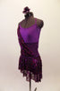 Plum cross-back short unitard base dress has purple mesh midriff & crystal accents along neckline. A purple sequin overlay is attached at right bust & cascades across front & back revealing leotard beneath. The sequin overlay acts as the skirt with a distinct plum waistband. Comes with floral hair accessory. Left side