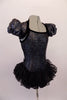 Charcoal crackle stone textured bodice has black piping and a short sassy pouffe sleeved shrug. The open back has double black bra-like straps that peak out beneath the shrug. A sweet multi layered ruffled lace skirt adds a touch of sweetness. Comes with antenna head band. Side