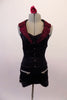 Biker themed short unitard has a fuchsia glitter lapel halter collar that attaches at the center of the bustline below the gathers. The fitted, open-backed torso is decorated with black and silver buttons along the front, that compliment the faux zipper pockets at the front of the shorts. Front