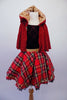 Black velvet leotard has a red glittery tartan pattern in the fabric. The accompanying red tartan skirt has gold waistband and sequin accent with black lace trim and tricot black petticoat. The finishing piece is a removable, gold lined, sparkly red hooded cape. Front