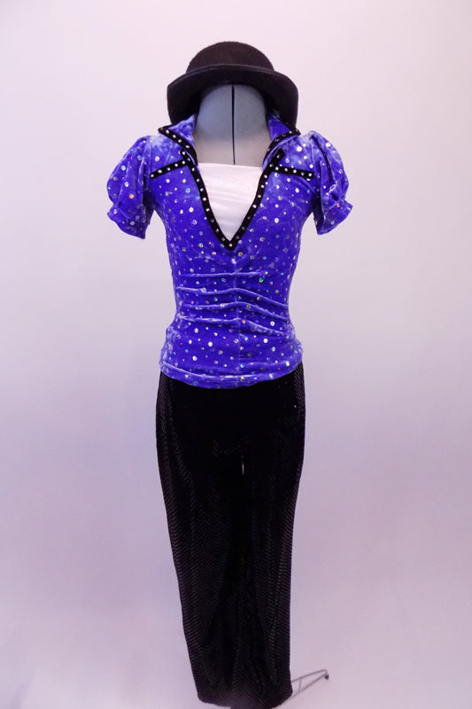 Two-piece costume has a periwinkle sequined velvet top with black trimmed lapelled collar, pouffe sleeves and white center inlay. The black trim is complemented by black velvet straight leg pants and a bowler hat. Front