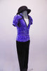 Two-piece costume has a periwinkle sequined velvet top with black trimmed lapelled collar, pouffe sleeves and white center inlay. The black trim is complemented by black velvet straight leg pants and a bowler hat. Right side with hat
